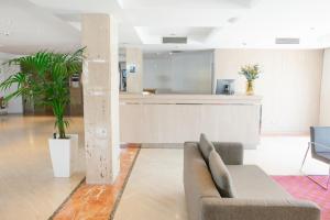 a living room with a couch and a counter at Port Azafata Valencia in Manises