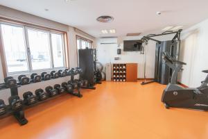 a gym with several treadmills and elliptical machines at Port Azafata Valencia in Manises