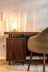 a table with a lamp on it next to a chair at Metro Loft in Póvoa de Varzim