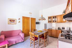 a kitchen and living room with a table and a couch at Paco House in Avola +29 photos
