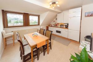 a kitchen and dining room with a table and chairs at Ferienwohnungen Bongarden in Bernkastel-Kues