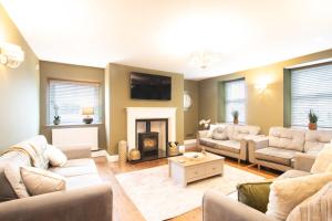 a living room with couches and a fireplace at Northern Hideaways, Brown Bear House in Berwick-Upon-Tweed +52 photos