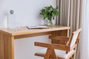 a wooden desk with a vase of flowers on it at 1.75 Paris La Source in Paris