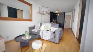a living room with a couch and a table at Charmant Appartement Les temples du Soleil in Font-Romeu-Odeillo-Via