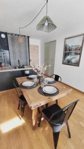 a wooden table with black chairs and a dining room at Charmant Appartement Les temples du Soleil in Font-Romeu-Odeillo-Via +26 photos