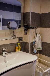 a bathroom with a sink and a mirror at Hotel les Sapins in La Clusaz +63 photos