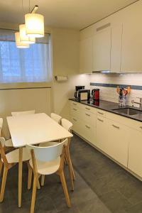 a kitchen with a table and chairs in a room at Apartment Haus Altein Apartment Nr- 4 by Interhome in Davos