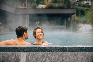 a man and a woman sitting in a fountain at Hotel Bad Fallenbach in San Leonardo in Passiria +94 photos