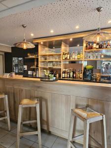 a bar with two wooden stools at a counter at Carpe Diem 2 in Goutrens