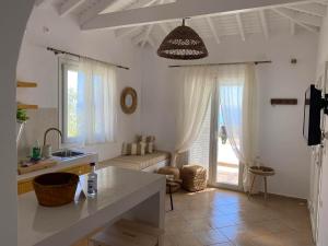 a kitchen and living room with a table and a couch at Nafsika Residences ex Petra Mare Village in Kerveli