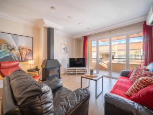 a living room with a couch and a fireplace at Apartment Mariners 4 by Interhome in Alcudia +15 photos