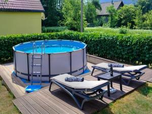 a pool with two lounges and two chairs and a table at Holiday Home Maja by Interhome in Lič