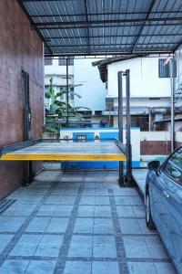 a blue and yellow table in a building with a car at Kovilakam Achutham in Guruvāyūr