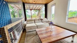 a living room with a couch and a table at Casa das Palmeiras in Imbituba