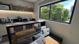 a dining room with a table and a window at Studio 48 - Lindo apto Studio no centro de Foz in Foz do Iguaçu