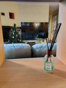 a living room with a christmas tree and a lamp on a table at Appartamento Sleep&Fly in Grassobbio