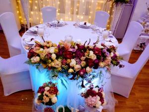 a table with a bunch of flowers on it at Hotel Lavica in Samobor