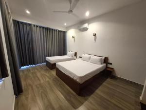 a bedroom with two beds and a window at Highgarden Hideaway Villa - Gampola in Gampola