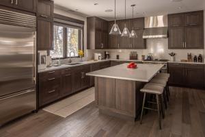 a kitchen with wooden cabinets and a large kitchen island at Spanish Peaks - Highlands Cabin 36 in Big Sky