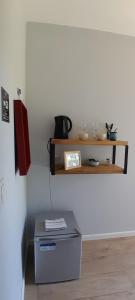 a room with a shelf on the wall and a table at Cantal Bed & Breakfast in El Durazno