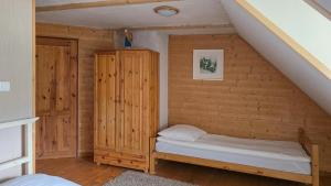 a bedroom with a bed in a log cabin at Eskapada in Stronie Śląskie