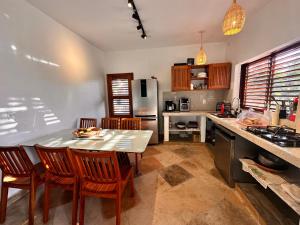 a kitchen with a table and chairs in a kitchen at casa nova in Cruz +9 photos