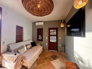 a living room with a couch in a room at casa nova in Cruz