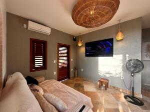 a living room with a couch and a fan at casa nova in Cruz
