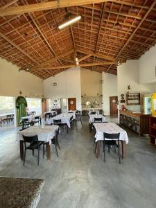 a restaurant with tables and chairs in a room at Pousada Café do Brejo in Triunfo