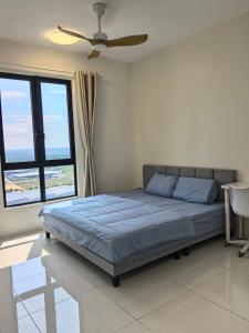 a bedroom with a bed and a ceiling fan at Batu Kawan Sunset Seaview Condo near Ikea & Design Village in Batu Kawan +27 photos