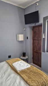 a bedroom with a bed and a door and a table at KeAnna STAYS units in Tsumeb
