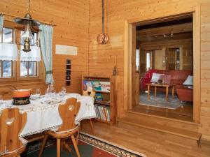 a dining room with a table and a living room at Chalet Kil-Ukru by Interhome in Ovronnaz