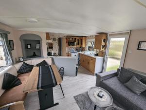 a living room and kitchen of a caravan at Beach Resort Kamperland - 1747 in Kamperland