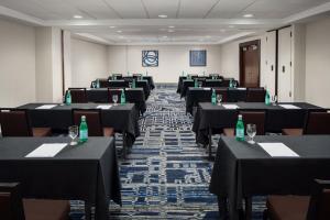 a room filled with tables and chairs with bottles on them at DoubleTree by Hilton Hotel & Suites Pittsburgh Downtown in Pittsburgh +85 photos