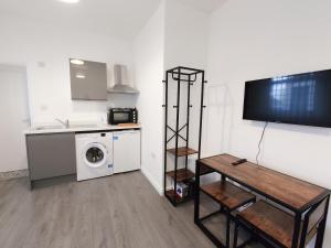 a kitchen with a washer and dryer in a room at Centra Station in London