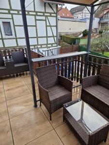 a balcony with two chairs and a table at Alex Meißner App 2 in Großalmerode