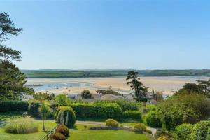a view of the beach from the garden of a resort at Beautiful Home with Pool Overlooking Camel Estuary in Roche