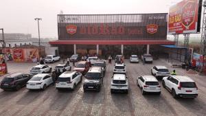 a parking lot with cars parked in front of a store at Old RAO Hotel Kotwan in Kosi