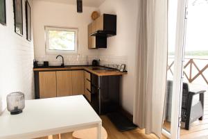 a small kitchen with a sink and a table at Przystań Kormoran in Czarna Wieś +40 photos