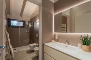a bathroom with a sink and a toilet and a mirror at Villa Il Platano in Como +57 photos