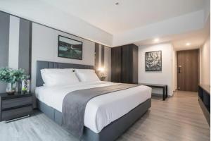 a bedroom with a large bed in a room at Luna hotel in Gua Sai