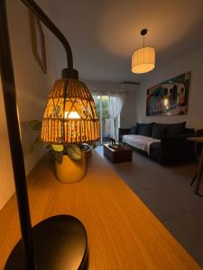a living room with a lamp and a couch at Charmant appart. 3-4 pers. in Saleilles