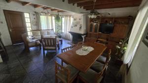 a living room with a table and a living room with a fireplace at La Casa de Lili in La Pedrera