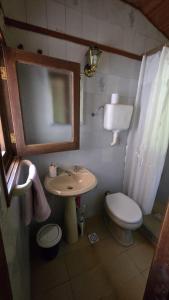 a bathroom with a sink and a toilet and a mirror at La Casa de Lili in La Pedrera +13 photos