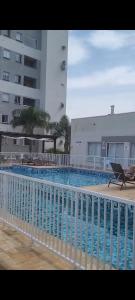 a large swimming pool in front of a building at Ap Clube Piçarras in Piçarras