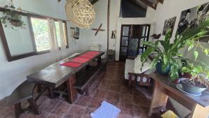 a room with a wooden bench and potted plants at La Casa de Lili in La Pedrera