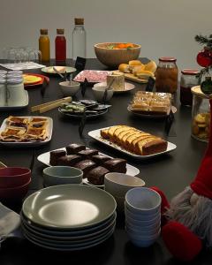 a table topped with plates of food and desserts at Cascina Ricardin in Coazzolo