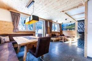 a living room with a dining table and a couch at Casa de Wisa in Gaschurn