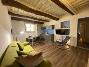 a living room with a yellow couch and a table at LuccaStay 99 in Lucca