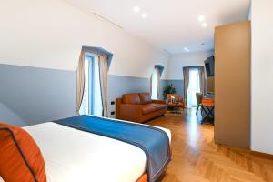 a bedroom with a bed and a living room at Hotel Astoria in Rapallo